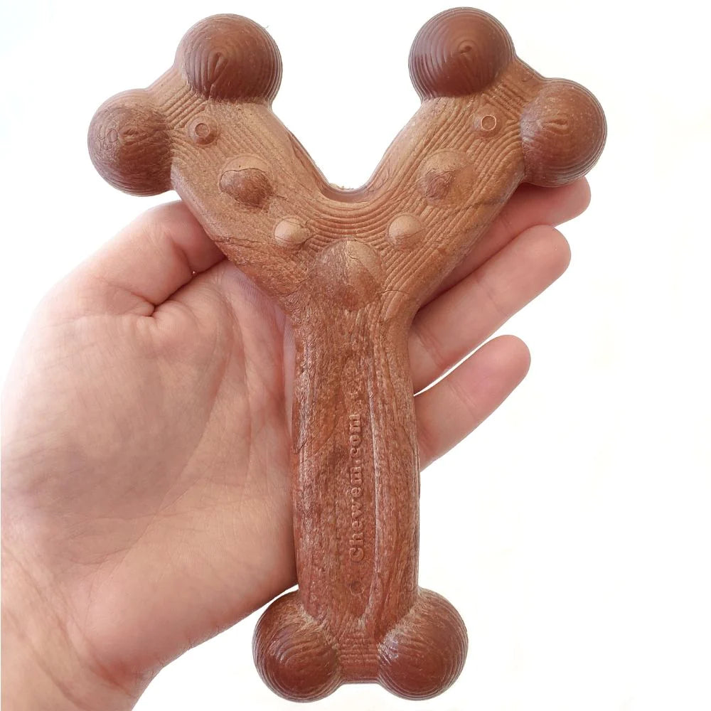 Large bacon-flavored Chew’ems durable nylon dog chew toy for aggressive chewers, held in a hand to show size.